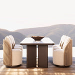 Load image into Gallery viewer, Corda woven outdoor dining chairs paired across sculptural dark table with mountain backdrop — luxury terrace seating — Minosé