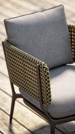 Load image into Gallery viewer, Cesto dining chair — close-up of woven back panel and metal frame junction — Minosé
