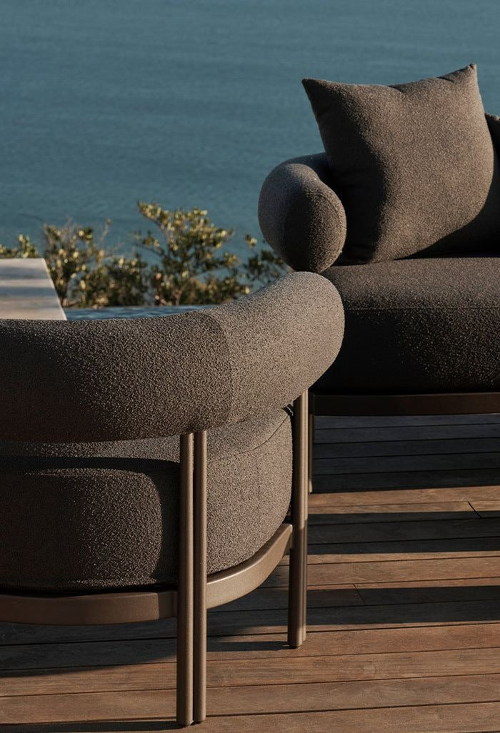 Rocchetto outdoor lounge chair in cream boucle — sculptural bolster form — desert garden setting — minosé