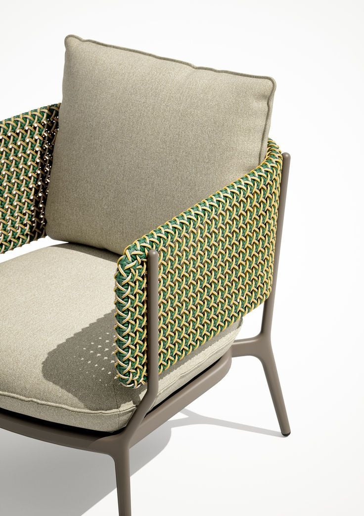 Cesto chair in sage green weave with cream linen seat — front three quarter view — minosé