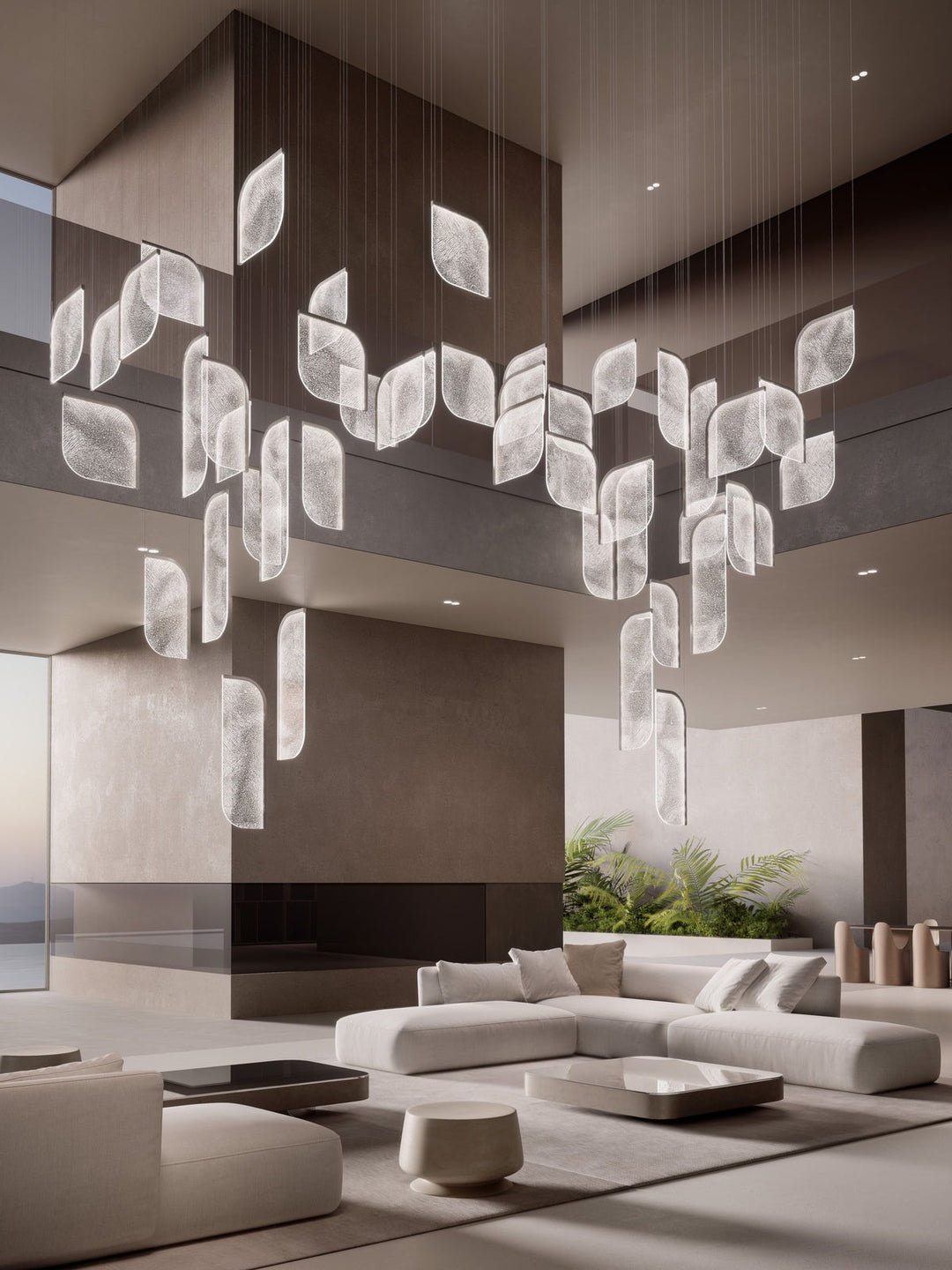 Foglia large chandelier — double-sided configuration in light finish — suspended over modern interior with cream seating — Minosé