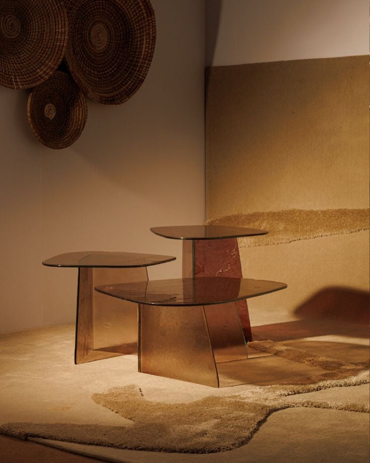 Luxury smoked glass sculptural side table with warm bronze tones by minosé