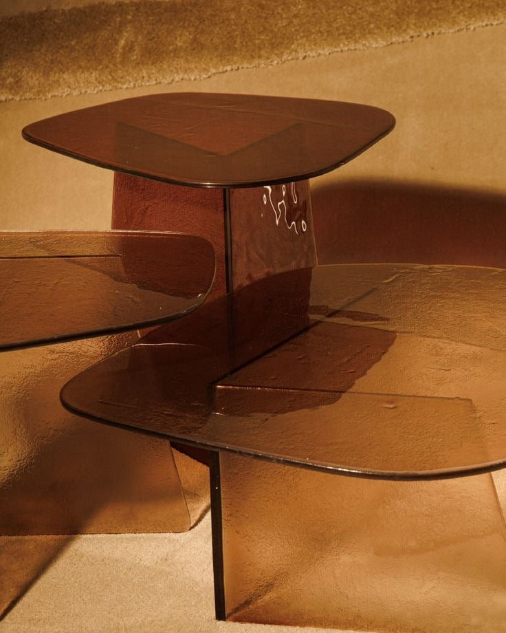 Luxury smoked glass sculptural side table with warm bronze tones by Minosé