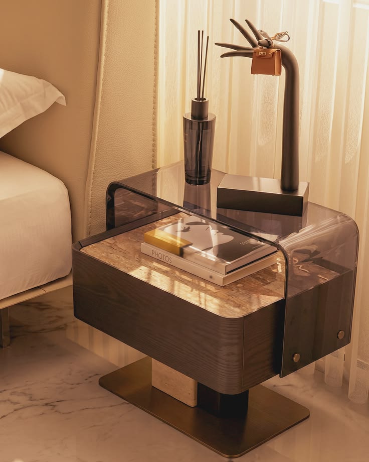 Luxury bedside table with smoked acrylic frame, marble top, and wood finish by minosé