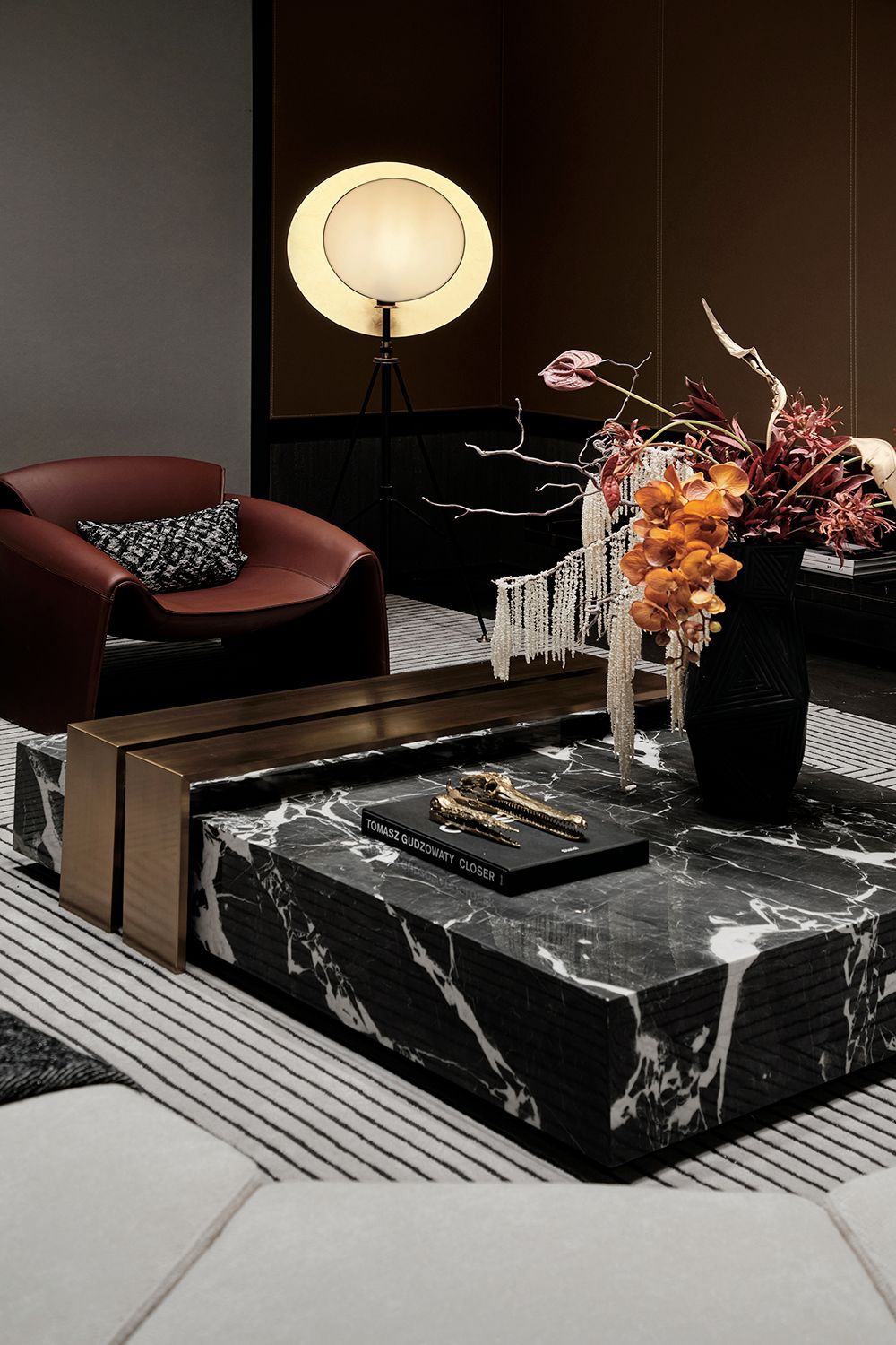 Luxury black marble center table with bronze sculptural accents by minosé