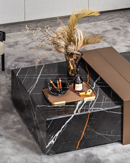 Luxury black marble center table with bronze sculptural accents by Minosé